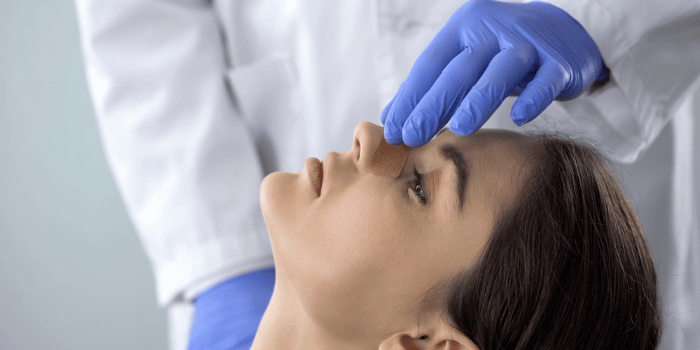 Doctor checks patient's nose after a rhinoplasty