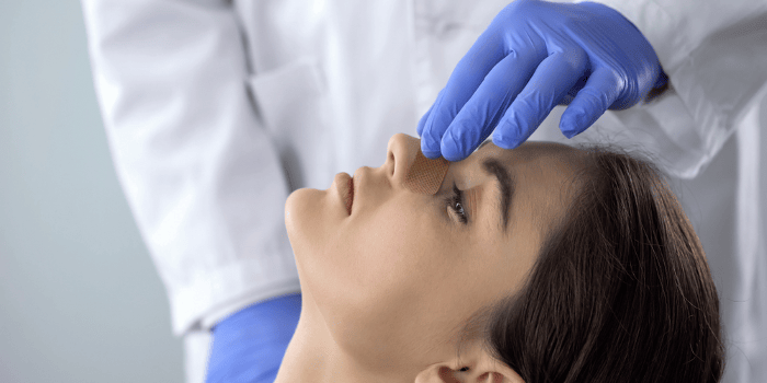 Doctor checks patient's nose after a rhinoplasty
