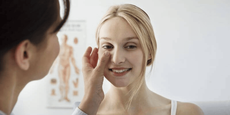 A doctor checks up on a Cinderella face lift patient
