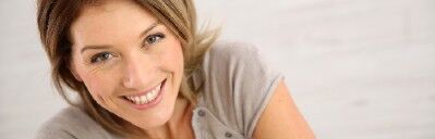Smiling woman looking towards the camera.
