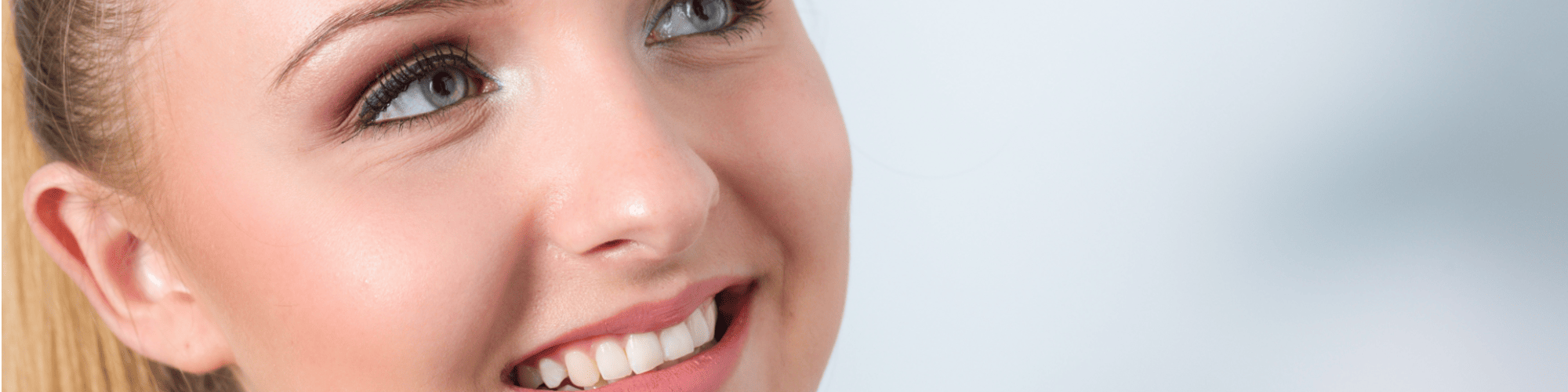 Patient smiling showing teeth before and after having veneers fitted. 