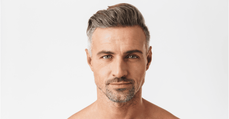 Man with thick hair after hair transplant surgery.