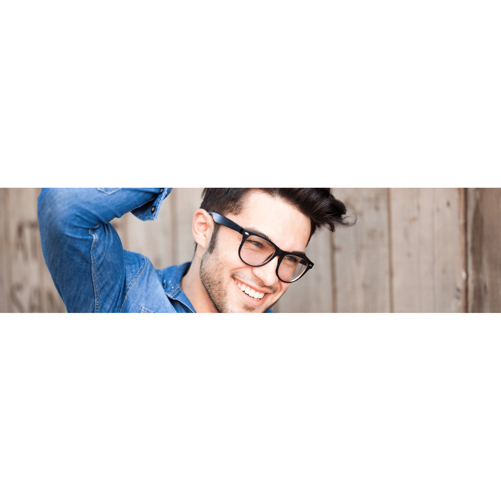 Man with thick head of hair smiling after undergoing a sapphire FUE hair transplant.