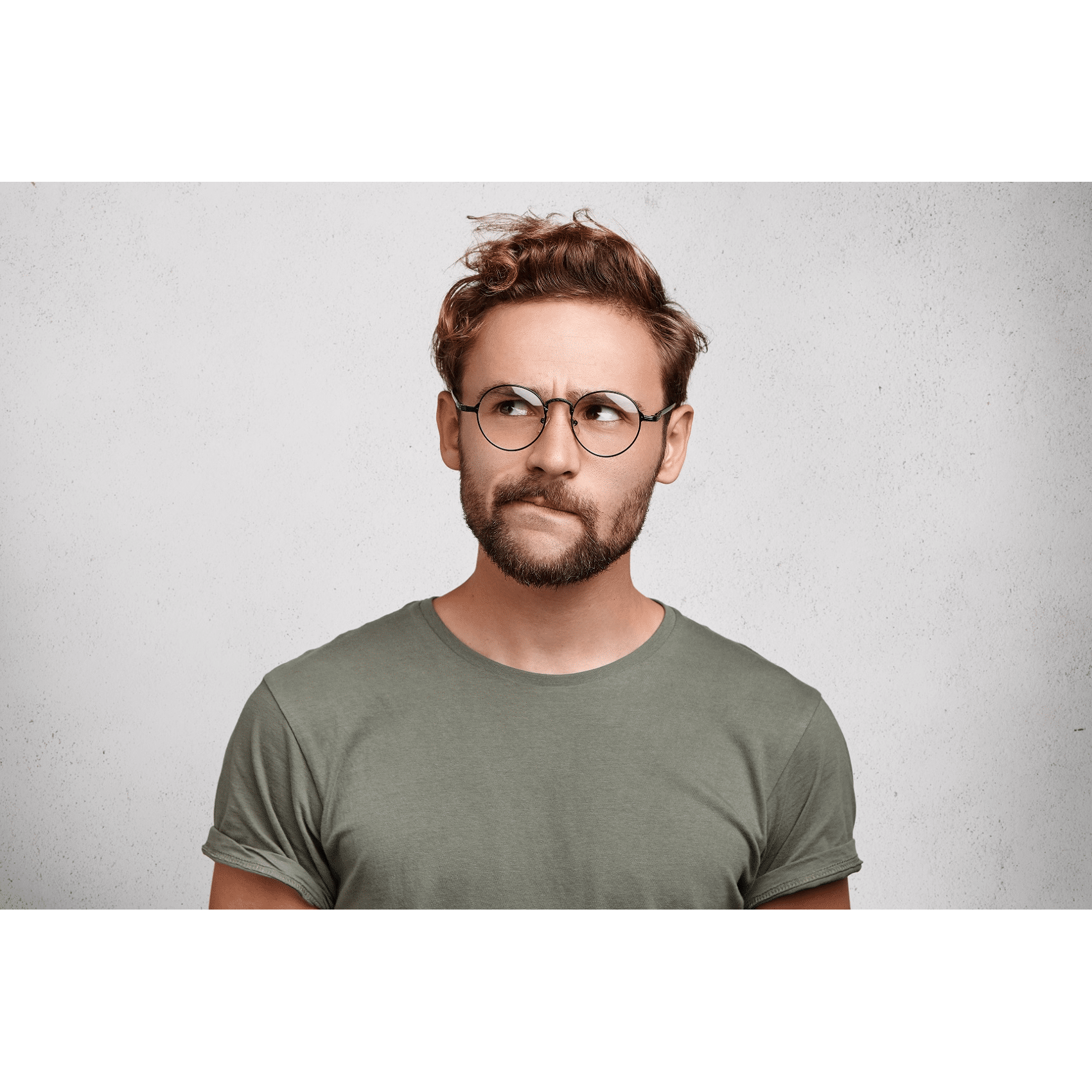Man in glasses thinking about his hair transplant aftercare