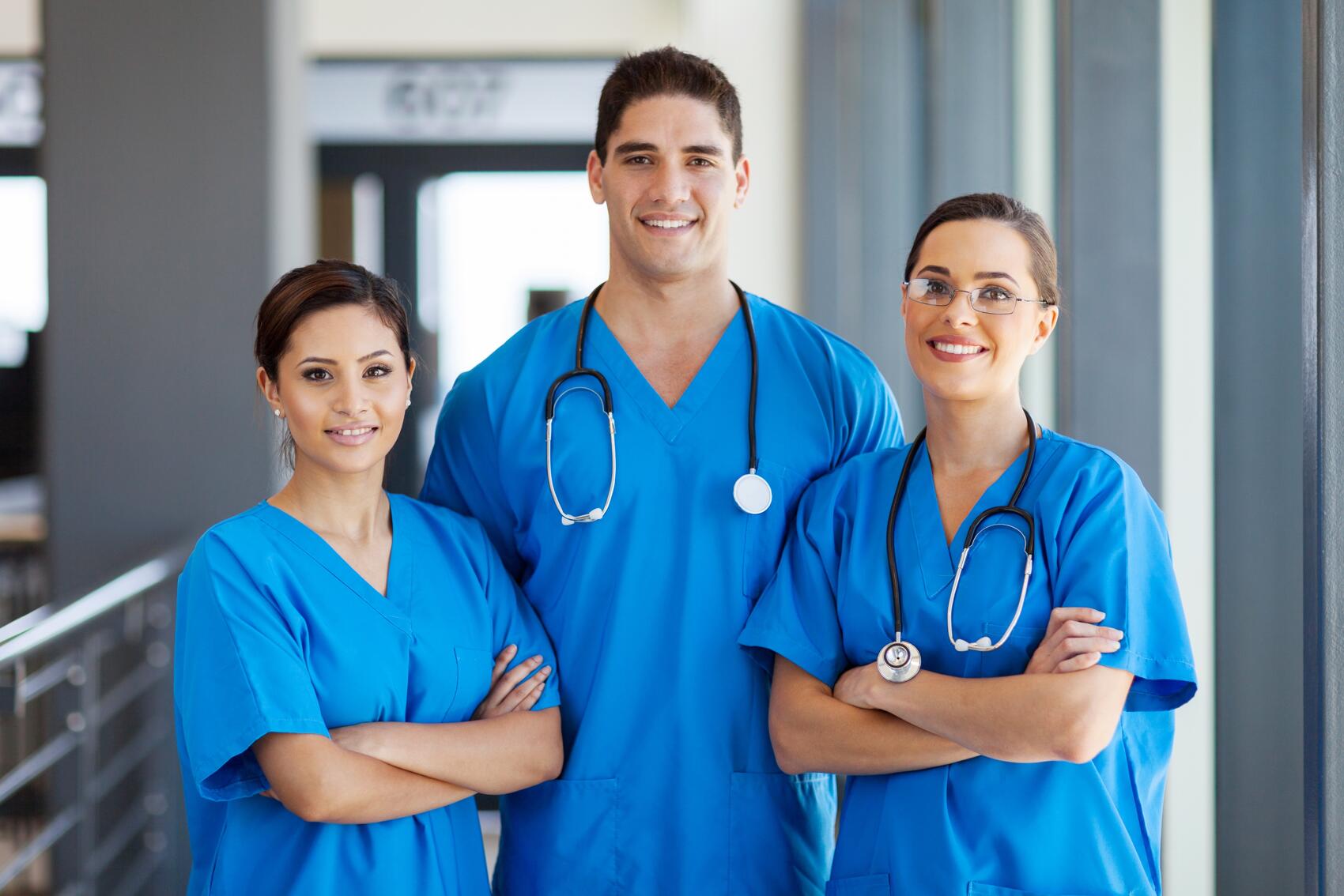 Female and male hair transplant technicians in scrubs in a hospital