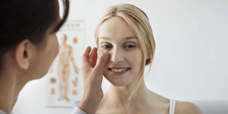 A doctor checks up on a Cinderella face lift patient
