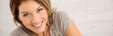 Smiling woman looking towards the camera.