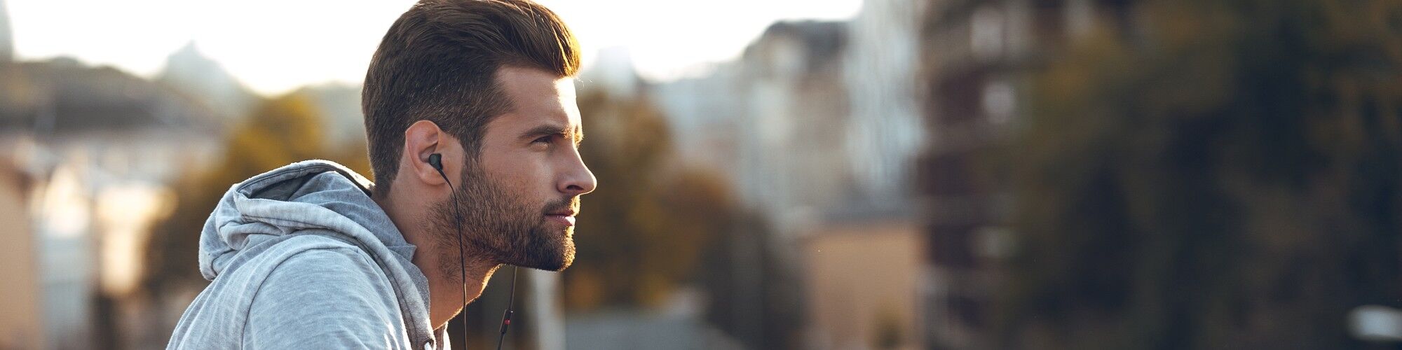 Doctor drawing lines on man's stomach to define areas of treatment for liposuction surgery.