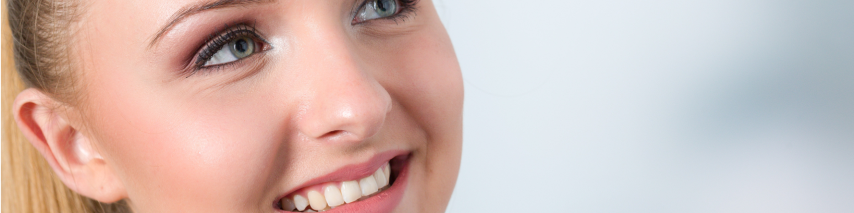 Patient smiling showing teeth before and after having veneers fitted.