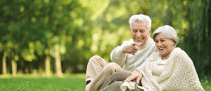 Couple sitting in park after neuro-orthopaedics treatment.