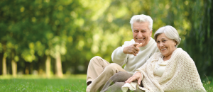 Couple sitting in park after neuro-orthopaedics treatment.